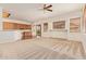 Spacious living area with plush carpet, ample light, and an open layout to the kitchen at 16768 W Nottingham Way, Surprise, AZ 85374