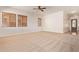 Bright and spacious living room with a ceiling fan and large windows at 16768 W Nottingham Way, Surprise, AZ 85374