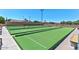 Well-maintained bocce ball courts surrounded by comfortable bench seating and beautiful landscaping at 6705 E Des Moines St, Mesa, AZ 85205