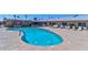 Inviting community pool with surrounding seating and mature tropical trees at 6705 E Des Moines St, Mesa, AZ 85205