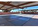 Outdoor shuffleboard courts featuring a covered seating area and beautifully landscaped surroundings at 6705 E Des Moines St, Mesa, AZ 85205