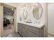 Bathroom featuring a double vanity, decorative mirrors, and a view of the bedroom at 10380 E Cholla St, Scottsdale, AZ 85260