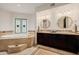 Large bathtub featuring decorative wall art and dark wood vanity at 10380 E Cholla St, Scottsdale, AZ 85260