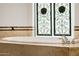 Close up of bathtub with metallic faucet and decorative panel at 10380 E Cholla St, Scottsdale, AZ 85260