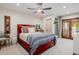 Bedroom with red bed frame, wood patio doors, and neutral walls at 10380 E Cholla St, Scottsdale, AZ 85260