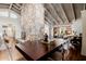 Bright dining room featuring a stone fireplace, wood floors, and clear acrylic chairs around a dark wood table at 10380 E Cholla St, Scottsdale, AZ 85260