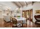 Charming dining area with a white round table, wicker chairs, and bright kitchen views at 10380 E Cholla St, Scottsdale, AZ 85260