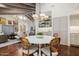 Open dining area with a round table next to the open floor plan and vaulted ceilings at 10380 E Cholla St, Scottsdale, AZ 85260