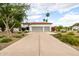 Charming home featuring a well-manicured front yard and a spacious driveway leading to a two-car garage at 10380 E Cholla St, Scottsdale, AZ 85260