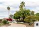 Single-story desert home with lush front yard landscaping and a bougainvillea-covered entryway at 10380 E Cholla St, Scottsdale, AZ 85260