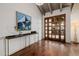 Stylish foyer with hardwood floors, a wooden door with glass panels, and elegant decor, creating a welcoming ambiance at 10380 E Cholla St, Scottsdale, AZ 85260
