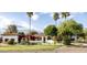 Charming single-story home featuring white stucco, desert landscaping, and a beautiful red tile roof at 10380 E Cholla St, Scottsdale, AZ 85260