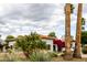 Palm trees accent this desert home with a Spanish tile roof and blooming bougainvillea lining the entrance at 10380 E Cholla St, Scottsdale, AZ 85260