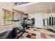Home gym with exercise equipment, mirrored wall, and rubber flooring; ideal for fitness enthusiasts at 10380 E Cholla St, Scottsdale, AZ 85260