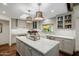 Bright, renovated kitchen featuring an island with marble countertops and stainless steel appliances at 10380 E Cholla St, Scottsdale, AZ 85260
