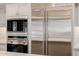 Updated kitchen appliances with stainless steel double door refrigerator and microwave at 10380 E Cholla St, Scottsdale, AZ 85260