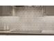 Close-up of the kitchen's detailed backsplash and countertops with modern appliances at 10380 E Cholla St, Scottsdale, AZ 85260