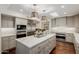 Elegant kitchen featuring marble countertops, a center island, stainless steel appliances, and a skylight at 10380 E Cholla St, Scottsdale, AZ 85260