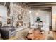 Inviting living room with a stone fireplace, exposed beam ceilings, and stylish decor creating a cozy and elegant atmosphere at 10380 E Cholla St, Scottsdale, AZ 85260