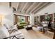 Bright living room with exposed beam ceiling, bay window, and stylish furnishings creating a comfortable and inviting space at 10380 E Cholla St, Scottsdale, AZ 85260