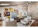 Open-concept living room featuring a stone fireplace, modern lighting, and comfortable seating at 10380 E Cholla St, Scottsdale, AZ 85260