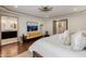 Open concept bedroom with hardwood floors, stylish lighting and adjoining bathroom at 10380 E Cholla St, Scottsdale, AZ 85260