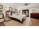 Well-lit bedroom with a king-size bed, wood floors, and backyard access at 10380 E Cholla St, Scottsdale, AZ 85260
