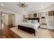 Spacious bedroom with king bed, gallery wall, and neutral color palette at 10380 E Cholla St, Scottsdale, AZ 85260