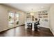 Bright office with hardwood floors, built-in shelves, a large desk, and french doors to the outside at 10380 E Cholla St, Scottsdale, AZ 85260