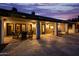 Covered patio with stone flooring and comfortable seating, perfect for enjoying outdoor living and entertaining at 10380 E Cholla St, Scottsdale, AZ 85260