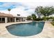 Aerial view of pool with patio space, outdoor fireplace, and backyard perfect for relaxing at 10380 E Cholla St, Scottsdale, AZ 85260