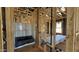 New construction bathroom featuring a tub, wood framing, and window at 11423 E Utah Ave, Mesa, AZ 85212