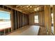 New construction bedroom framing with a window for natural light and OSB subfloor at 11423 E Utah Ave, Mesa, AZ 85212