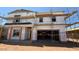 New construction home featuring unfinished exterior, scaffolding, and garage door opening at 11423 E Utah Ave, Mesa, AZ 85212