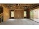 Unfinished living room featuring a staircase, dual windows, and sliding glass doors at 11423 E Utah Ave, Mesa, AZ 85212