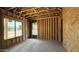 Unfinished new construction with wood framing, large windows, and natural light at 11423 E Utah Ave, Mesa, AZ 85212