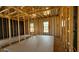 Unfinished living room exhibiting wooden framing, drywall, and window views at 11423 E Utah Ave, Mesa, AZ 85212