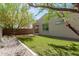 A well-manicured backyard featuring artificial grass and low-maintenance landscaping for easy outdoor enjoyment at 14114 W Surrey Dr, Surprise, AZ 85379