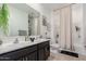 Bathroom with double sinks, granite counters and a shower and tub combination at 14114 W Surrey Dr, Surprise, AZ 85379