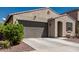 Charming single-story home with a two-car garage, desert landscaping, and a welcoming front entrance at 14114 W Surrey Dr, Surprise, AZ 85379