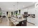 Spacious kitchen island featuring granite countertops, stylish seating, stainless steel appliances, and an open layout at 14114 W Surrey Dr, Surprise, AZ 85379