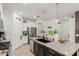 Contemporary kitchen featuring stainless steel appliances, granite countertops, dark wood cabinets, and pendant lighting at 14114 W Surrey Dr, Surprise, AZ 85379