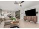 Spacious living room featuring tile floors, stylish decor, and an open layout with views of the dining area and kitchen at 14114 W Surrey Dr, Surprise, AZ 85379