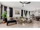 Bright living room with tile flooring, modern furnishings, and views into the adjacent dining and kitchen areas at 14114 W Surrey Dr, Surprise, AZ 85379