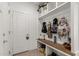 Organized mudroom featuring a built-in bench with storage and plenty of hooks for coats and bags at 14114 W Surrey Dr, Surprise, AZ 85379