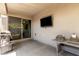 Enclosed patio with a grill, television, and sliding doors, providing a versatile outdoor living space at 14114 W Surrey Dr, Surprise, AZ 85379