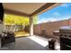 Covered outdoor patio, perfect for grilling and entertaining, with a view of a vibrant yellow tree at 14114 W Surrey Dr, Surprise, AZ 85379