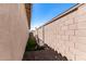 A functional side yard features gravel landscaping and block wall for added privacy and low maintenance at 14114 W Surrey Dr, Surprise, AZ 85379