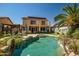 Spacious backyard featuring a large pool, outdoor kitchen, and two-story home at 14246 W Columbus Ave, Goodyear, AZ 85395