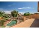 Expansive deck view showcasing the backyard oasis with a pool, lush landscaping, and surrounding neighborhood scenery at 14246 W Columbus Ave, Goodyear, AZ 85395